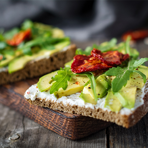 Avocado toast on a wood board.