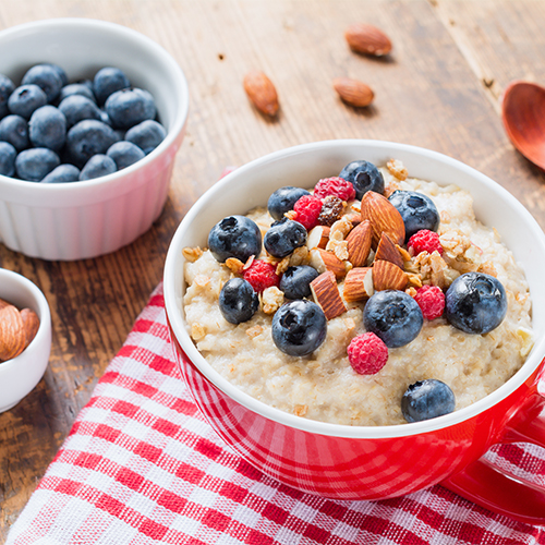 A bowl of oatmeal and fruit.
