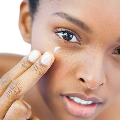 woman touching under eye
