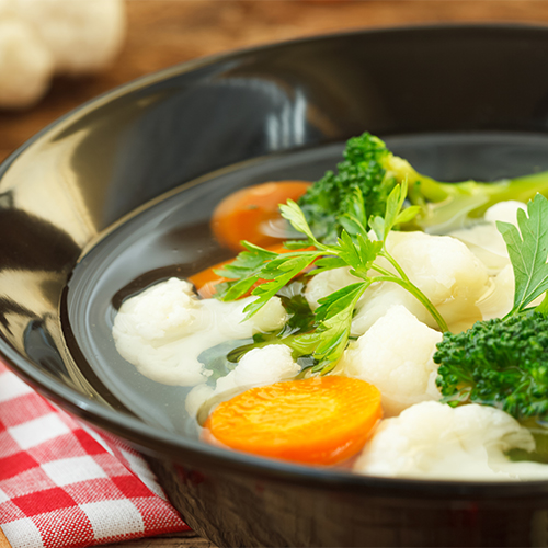 Vegetable Soup in a black bowl.
