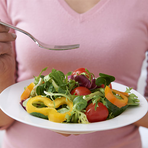 A person eating salad.