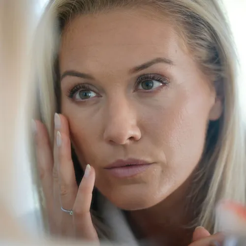woman looking in mirror