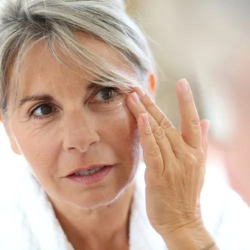 woman putting on cream