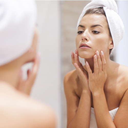 woman looking in mirror