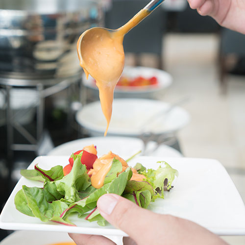 thousand island dressing poured on salad