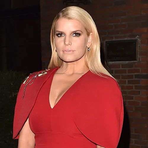 Jessica Simpson in a glamorous dress at a red carpet event.