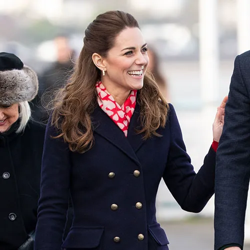 Kate Middleton smiling at a royal engagement.