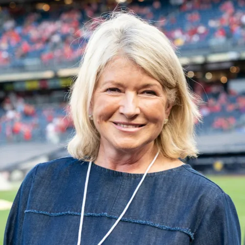 Martha Stewart smiling at a public event, showcasing her style.