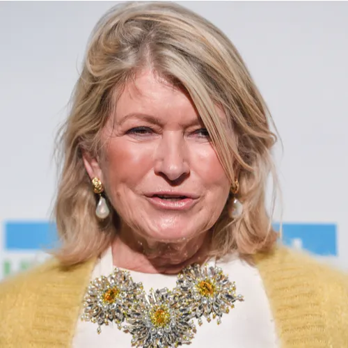 Martha Stewart engaged in a cooking demonstration, displaying her culinary skills.