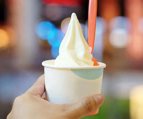 Delicious frozen yogurt topped with fresh fruits and sprinkles.
