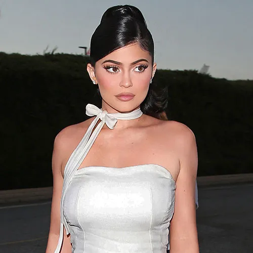 Kylie Jenner posing in her red latex gown for Vogue.