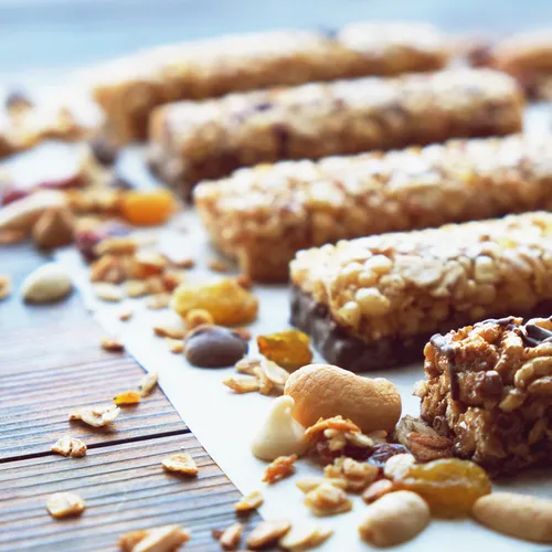 Nutritious protein bars stacked on a wooden table.