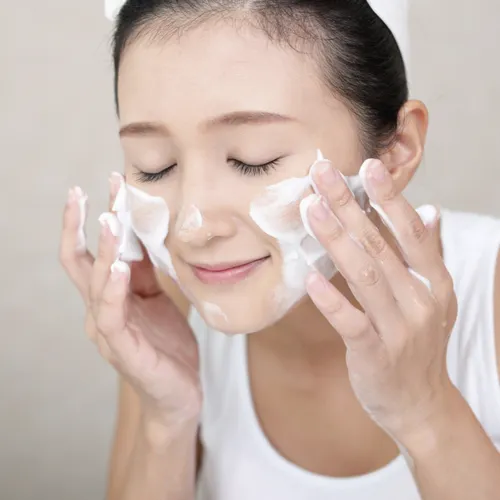 "Woman applying skincare products"