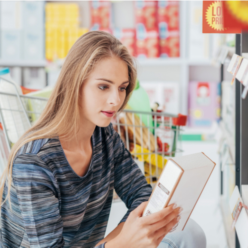 woman reading nutrition label