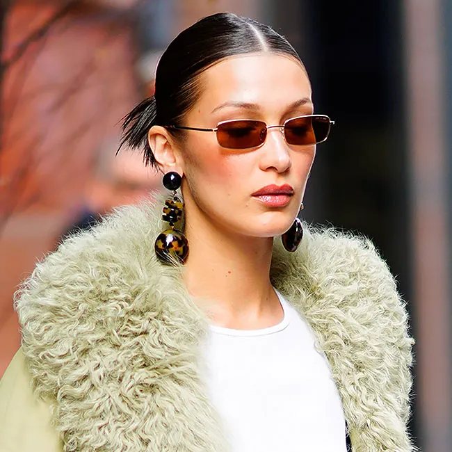 Bella Hadid posing confidently in a fashionable outfit.