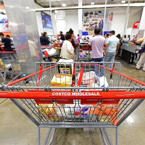Customers checking out at a Costco register.