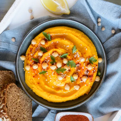 Creamy garlic hummus served with pita bread