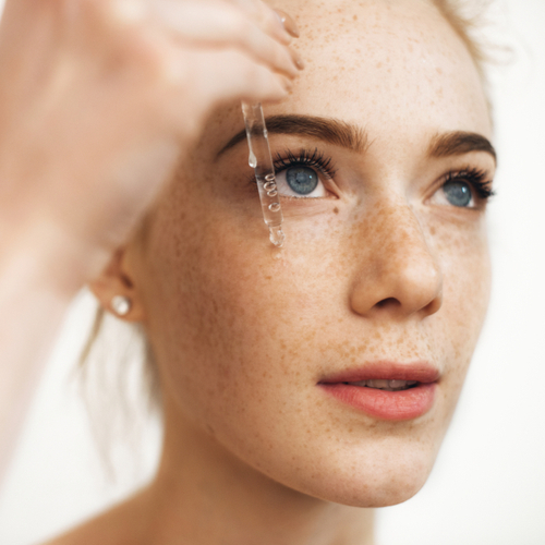 woman applying serum