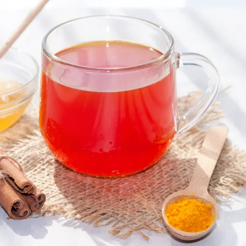 Golden turmeric tea in a cozy cup