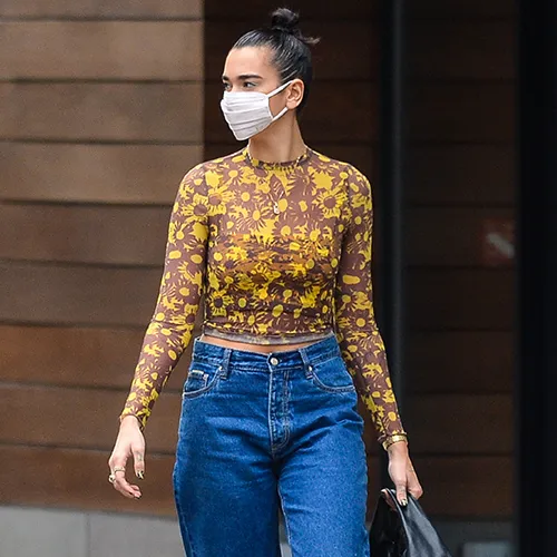 Dua Lipa showcasing a stunning fashion look on stage.