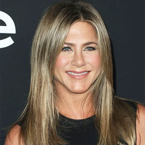 "Jennifer Aniston smiling at an event"