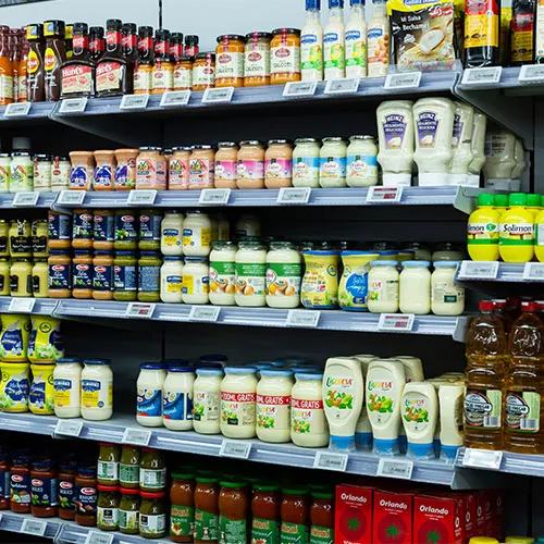 Variety of condiments arranged on a store shelf