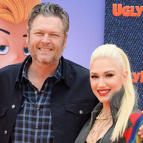 Gwen Stefani and Blake Shelton smiling together at a celebration.