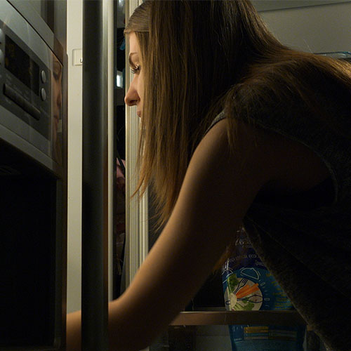 woman looking in fridge