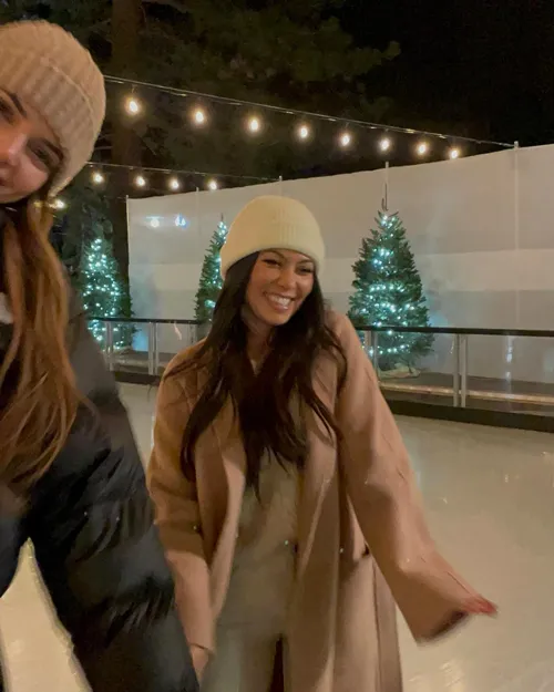 "Kourtney Kardashian smiling during ice skating"