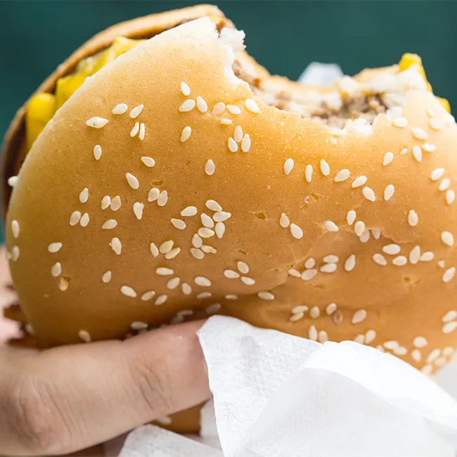 Close-up of McDonald's McRib sandwich on a table.