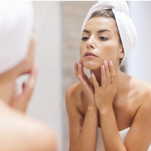 woman looking in mirror