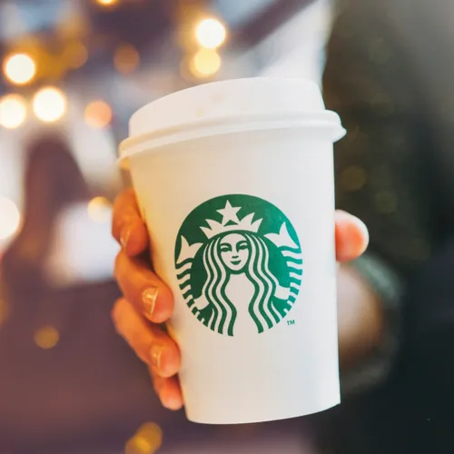 Starbucks barista preparing a fresh cup of coffee.