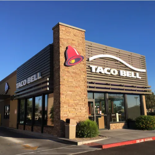 Flavorful Taco Bell burrito wrapped in foil, ready to eat.