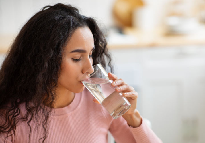 Woman drinking water.