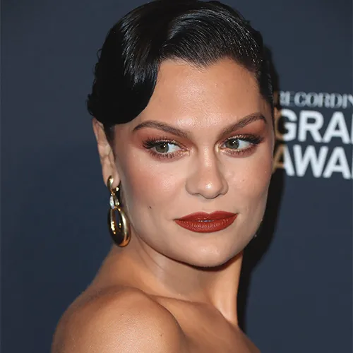 Jessie J posing confidently in a fashionable ensemble.