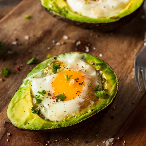 "A colorful breakfast bowl with eggs and vegetables"