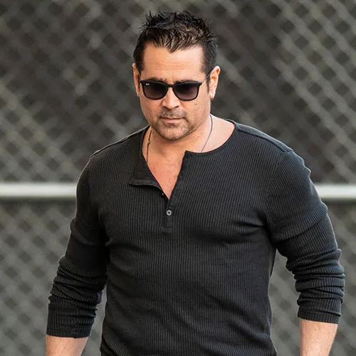 Colin Farrell attending a glamorous event in stylish attire.