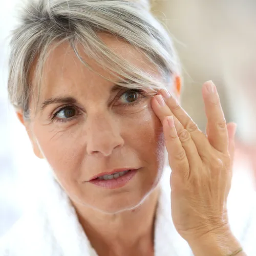 woman looking at wrinkles