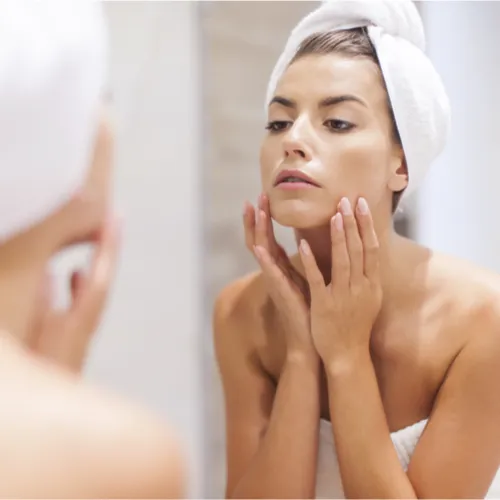 woman looking in mirror