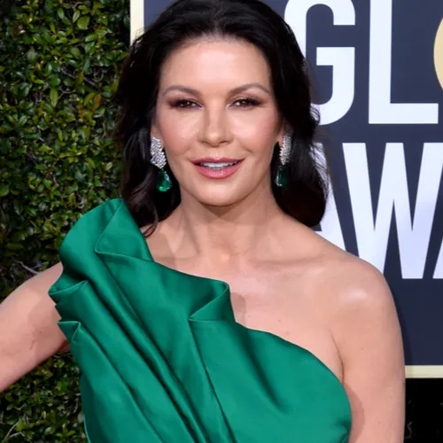 Catherine Zeta-Jones looks glamorous in a sophisticated dress.