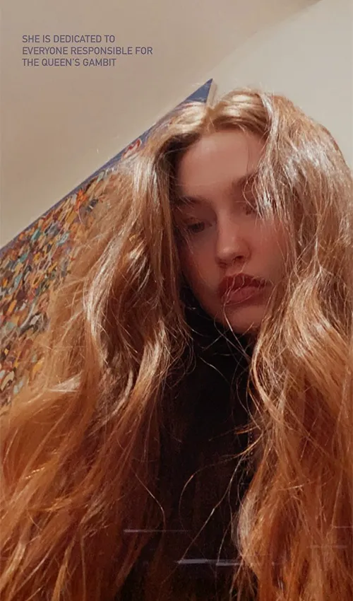 Gigi Hadid in a striking outfit during a photoshoot.