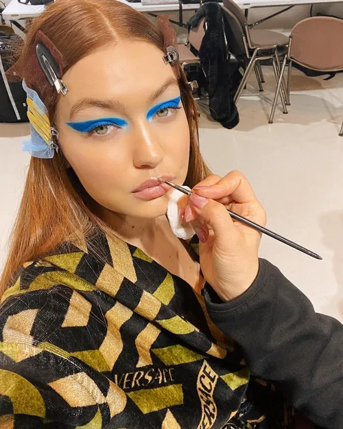 Gigi Hadid posing confidently in a glamorous setting.