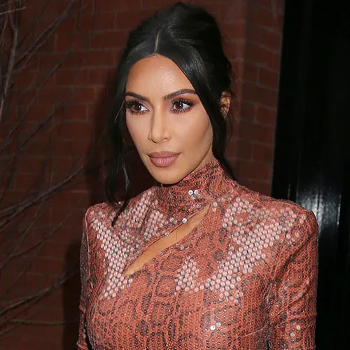 Kim Kardashian smiling in a chic casual look.