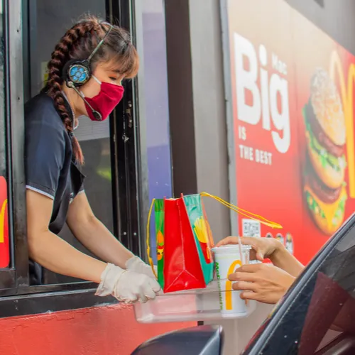 Cars waiting in line at McDonald's drive-thru.