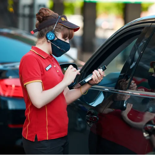 Busy McDonald's drive-thru with customers ordering food.