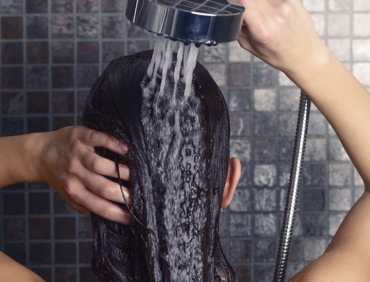 Rinsing shampoo out of hair.