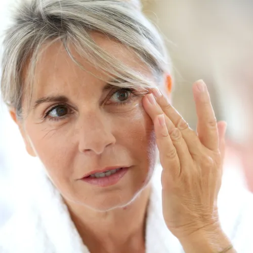 "Woman applying skincare"