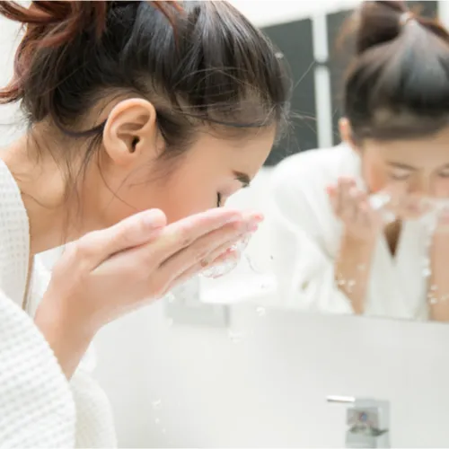 woman washing face