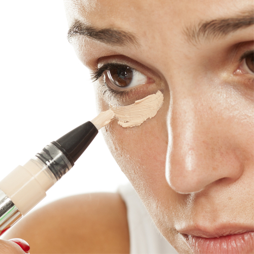 woman applying concealer