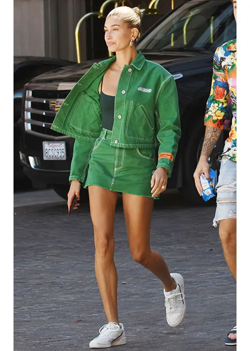 Hailey Bieber striking a pose in chic fashion attire.